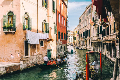 Gondolas amidst buildings in city