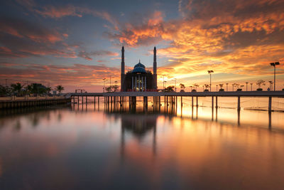 Scenic view of sea against cloudy sky during sunset