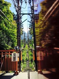 Railroad tracks by trees against sky