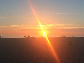 Scenic view of beach against sky during sunset
