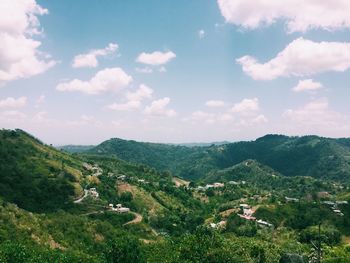 Scenic view of mountains against cloudy sky