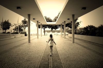 Rear view of man standing on street in city