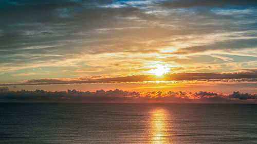Scenic view of sea against romantic sky at sunset