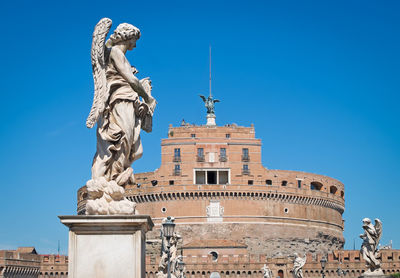Statues at castel sant angelo against clear blue sky