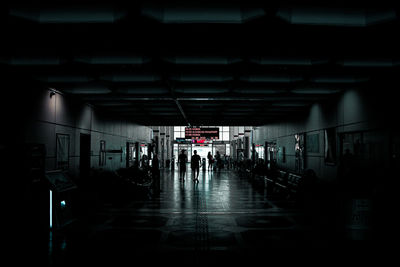 People walking in corridor of building