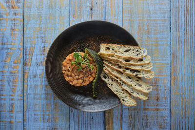 Gourmet fish tartar raw from tuna fillet with hashed avocado, selective focus