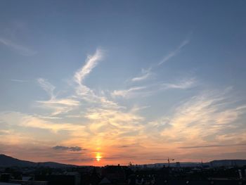 Silhouette buildings against sky during sunset