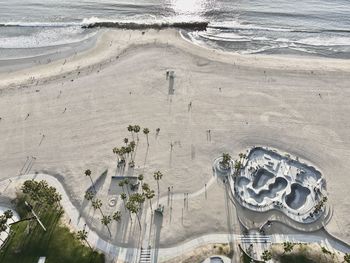 Aerial perspective of venice beach skatepark and bike path at sunset.