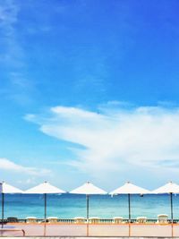 Scenic view of beach against blue sky