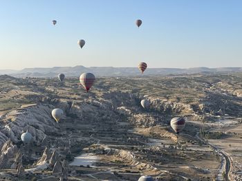 View of hot air balloons flying over rocks