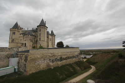 Historic building against cloudy sky