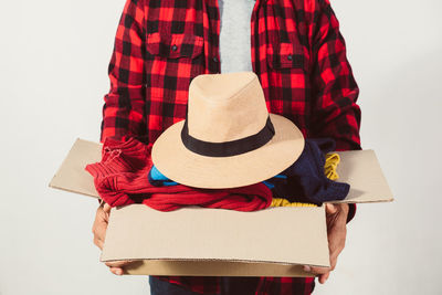 Rear view of woman wearing hat against white background