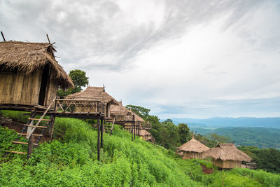 Built structure on grassy landscape against sky
