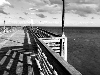 Pier over sea against sky