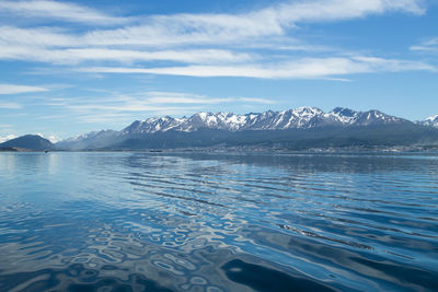 Scenic view of sea and mountains against sky