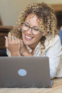 Friends using laptop at home