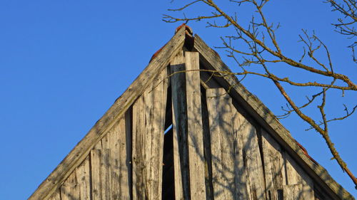 Low angle view of building against clear blue sky