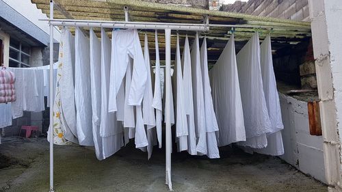 Clothes drying on clothesline against building