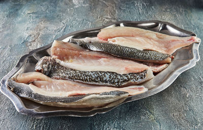 Fresh bass fish, ready to cook on tray