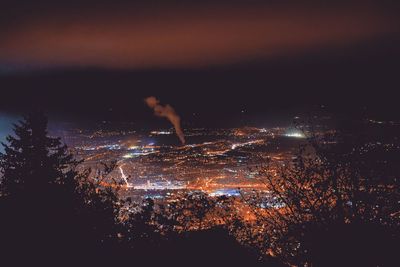 Close-up of illuminated lights against sky at night