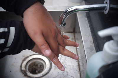 Midsection of people holding water at home