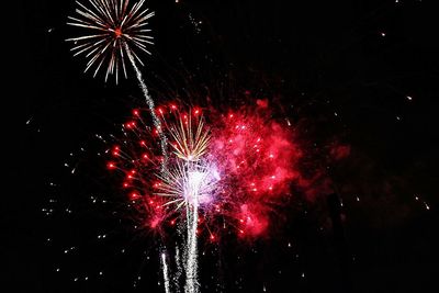 Low angle view of firework display at night