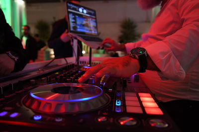 Midsection of man using sound mixer