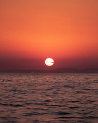 Scenic view of sea against romantic sky at sunset