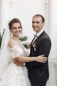 Portrait of smiling couple standing in office