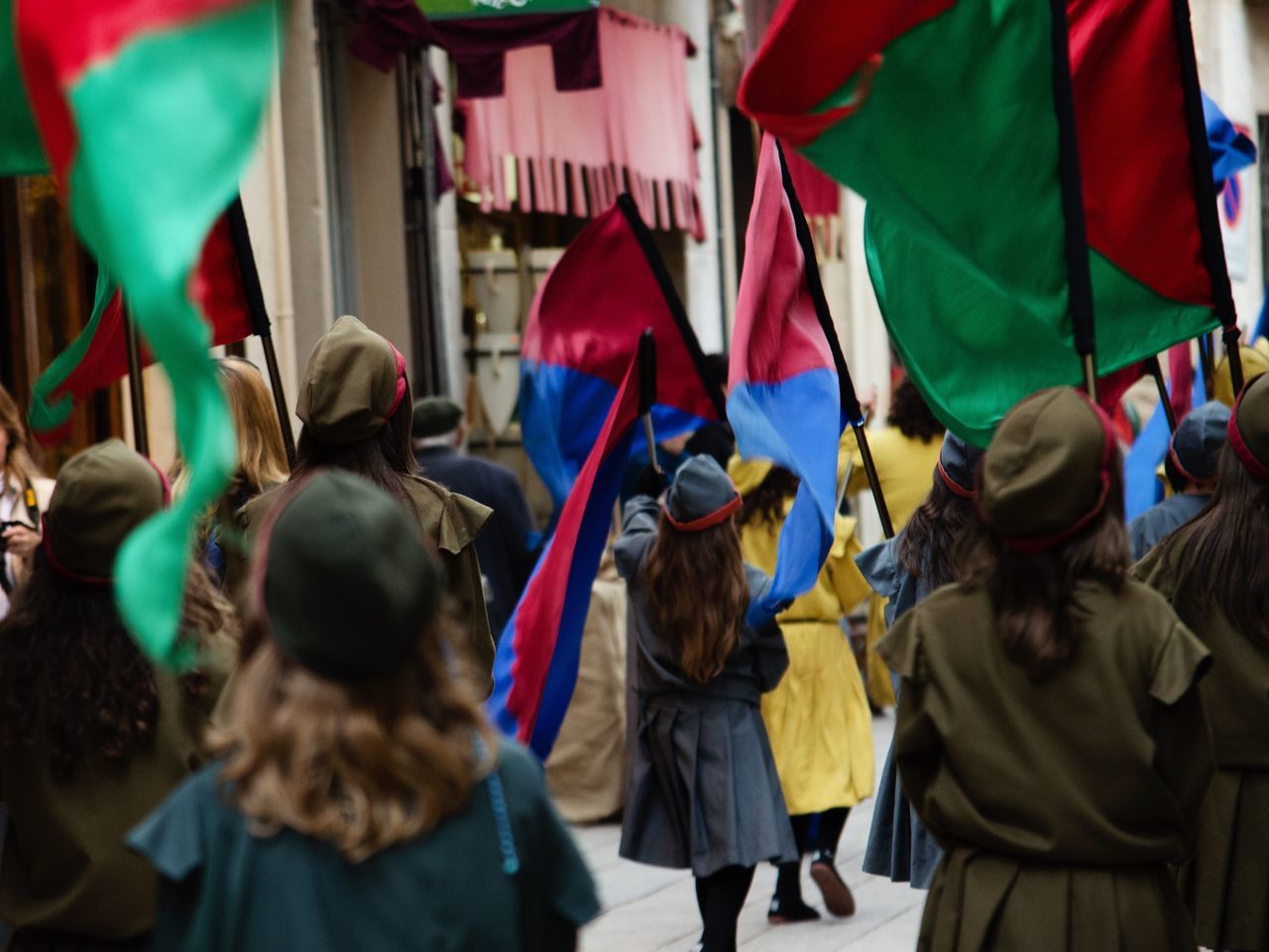 group of people, flag, real people, crowd, women, city, day, men, people, adult, architecture, street, patriotism, togetherness, rear view, lifestyles, emotion, group, outdoors, protestor