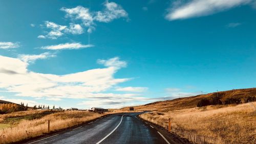 Empty road along countryside landscape