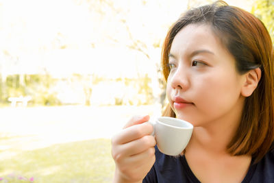 Close-up of woman holding coffee cup