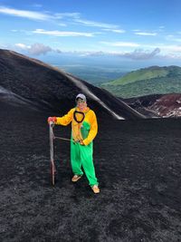 Man standing on mountain against sky