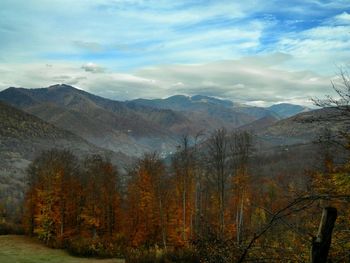 Scenic view of mountains against cloudy sky