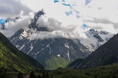 Scenic view of snowcapped mountains against sky