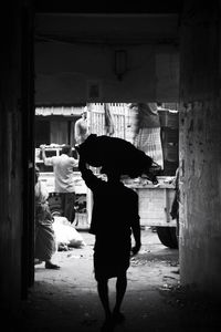 Rear view of people standing in corridor