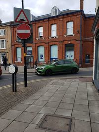 Cars on road by buildings in city