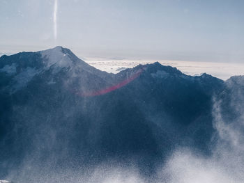 Scenic view of snow mountains against sky