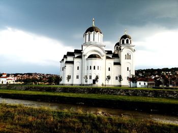 Church by building against sky