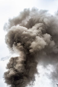 Low angle view of smoke emitting from clouds