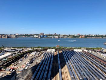 High angle view of buildings by sea against clear sky