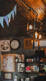 Low angle view of illuminated pendant light hanging in restaurant