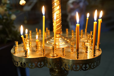 Close-up of illuminated candles on table