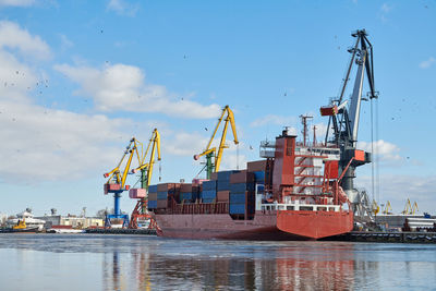 Moored cargo ships and harbor cranes in port. seaport, cargo container yard, container ship terminal