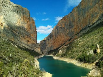 Scenic view of river and mountains against sky