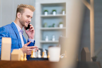 Businessman talking on mobile phone in restaurant