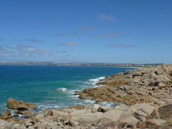 Scenic view of sea against blue sky