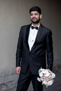 Portrait of businessman holding bouquet