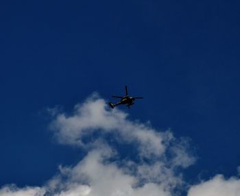 Low angle view of airplane flying in sky