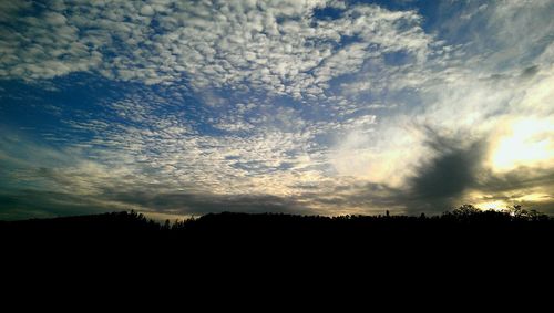 Silhouette of landscape against sunset sky